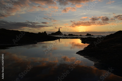 Corbiere lighthouse, Jersey, U.K. Spring coastal sunset.