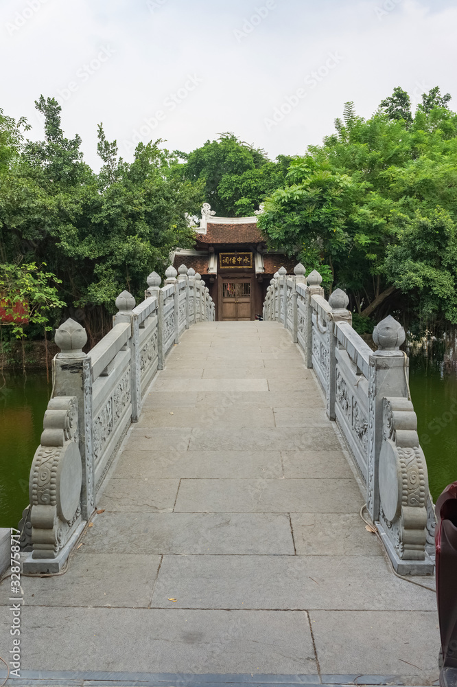Hanoi, Vietnam Oct 16, 2019. Very beautiful traditional bridge to the temple on the lake. Vertical Hanoi, Vietnam Oct 16, 2019. Very beautiful traditional bridge to the temple on the lake. Vertical