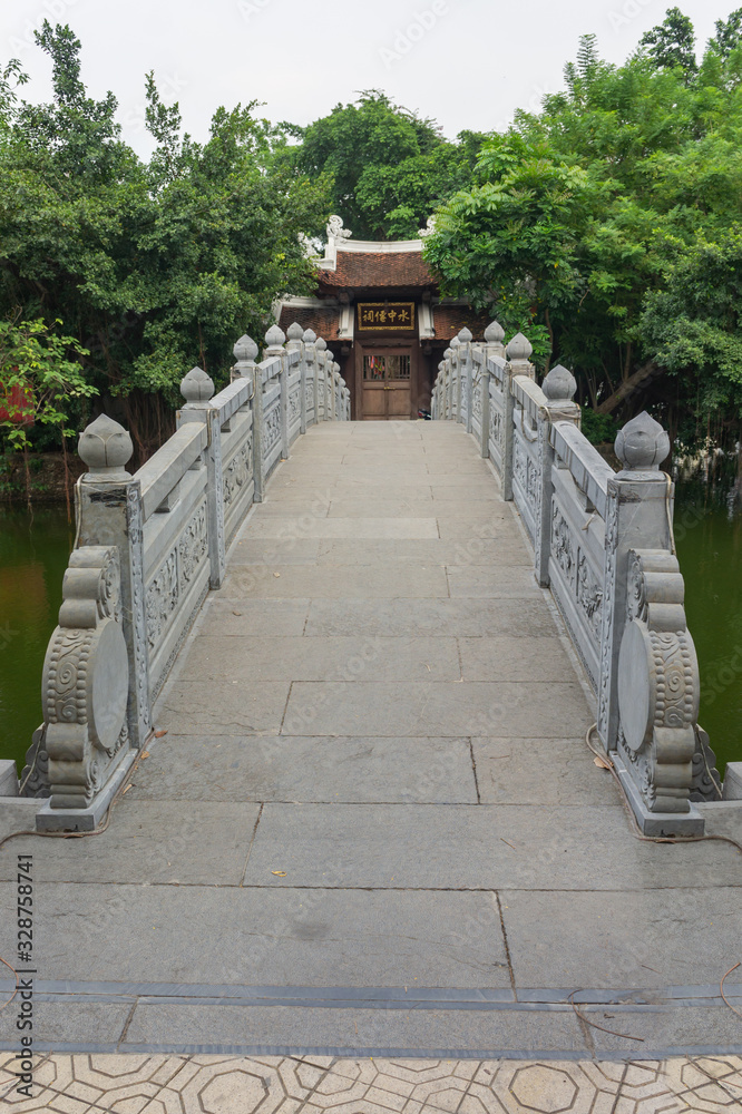 Hanoi, Vietnam Oct 16, 2019. Very beautiful traditional bridge to the temple on the lake. Hanoi, Vietnam Oct 16, 2019. Very beautiful traditional bridge to the temple on the lake.