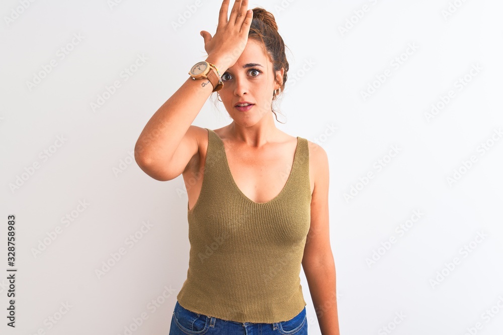 Young redhead woman wearing a bun over isolated background surprised with hand on head for mistake, remember error. Forgot, bad memory concept. Young redhead woman wearing a bun over isolated background surprised with hand on head for mistake, remember error. Forgot, bad memory concept.