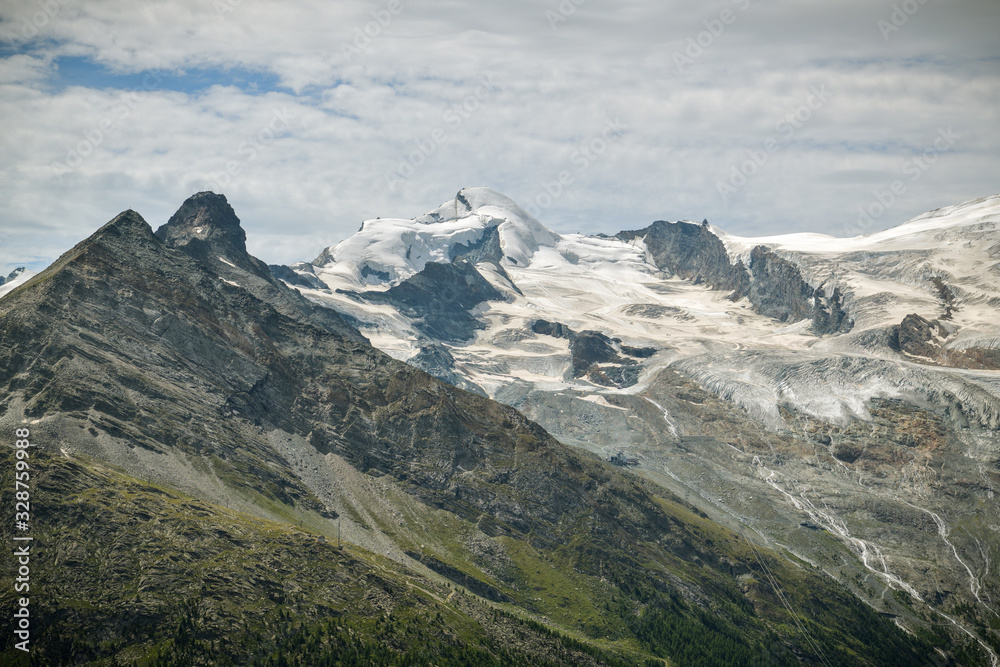 Detailed look on Allalin peak and Fee glacier above the Saas-Fee village in Swiss Alps