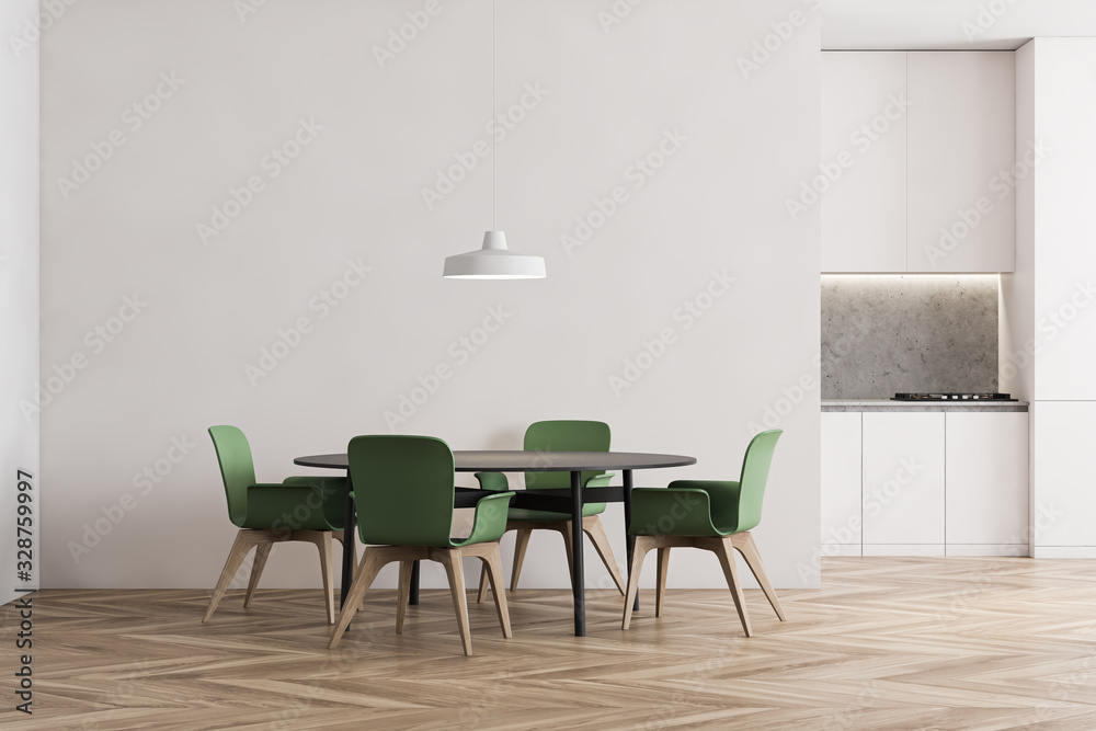 Fototapeta premium White kitchen with dining table and green chairs