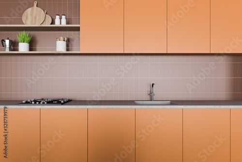 Brown tile kitchen interior with orange countertop