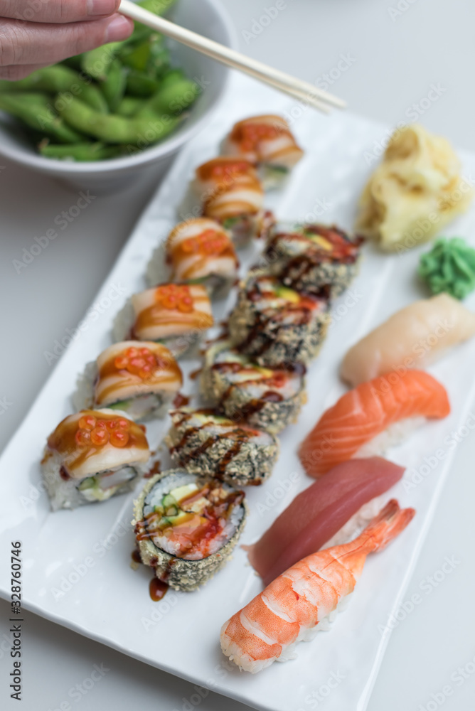 Sushi Roll Set with Seafood on White Plate. Lunch in Japanese Restaurant Sushi Roll Set with Seafood on White Plate. Lunch in Japanese Restaurant