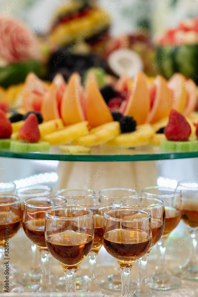 Alcoholic cocktail on festive table with watermelon, grape, banana and different fresh fruits. Celebration or other event