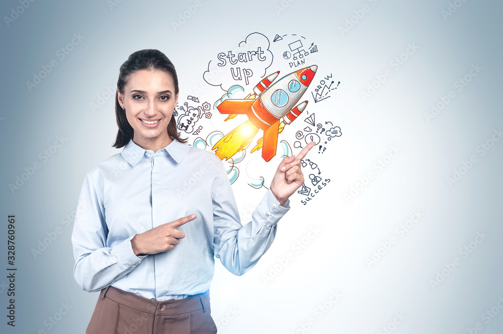 Smiling young woman pointing at startup sketch Smiling young woman pointing at startup sketch