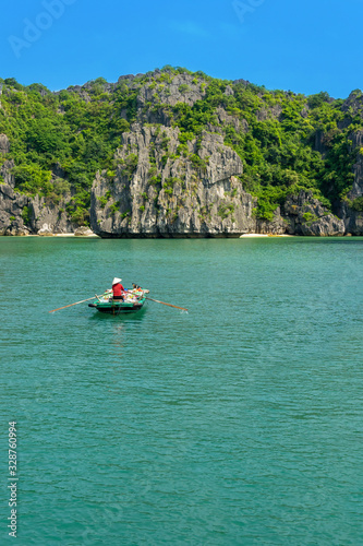 Halong bay islands. Tourist attraction, spectacular limestone grottos natural cave formations. Karst landforms in the sea, the world natural heritage. Beautiful azure water of the lagoon. boat market