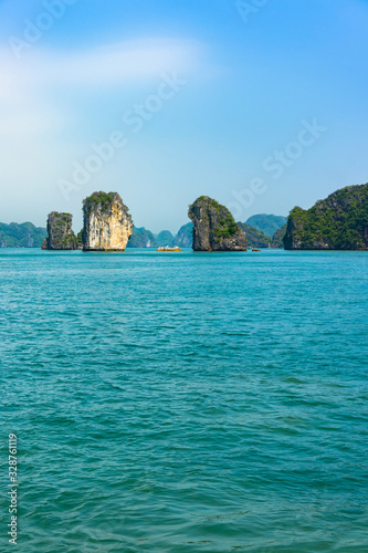 Two stone cliff-island in Halong Bay in Vietnam. UNESCO Ecosystem concept Site Asia. Tourist attraction of Halong bay islands, spectacular limestone grottos natural cave formations.