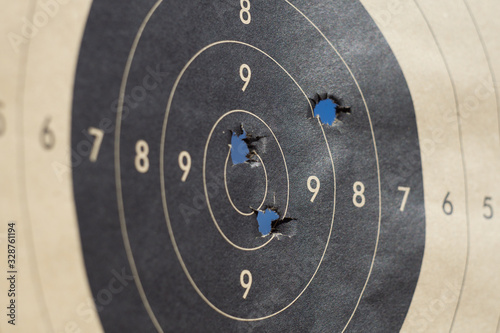 Close up of a shooting target and bullseye with bullet holes