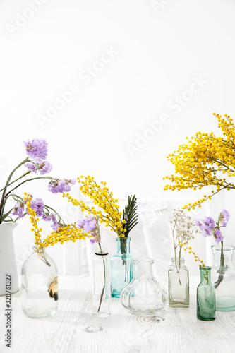 small variety of pharmacy bottles instead of a vase for dried flowers.