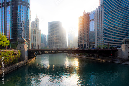A view of the Wabash Avenue Bridge with the early morning sun glaring in a haze between the distant buildings photo