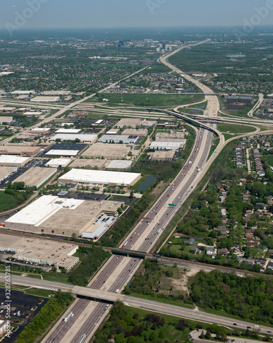 Looking down from the window of a plane coming in to land at O'Hare AIrport, , with a view of the highways, vehicles and surrounding buildings