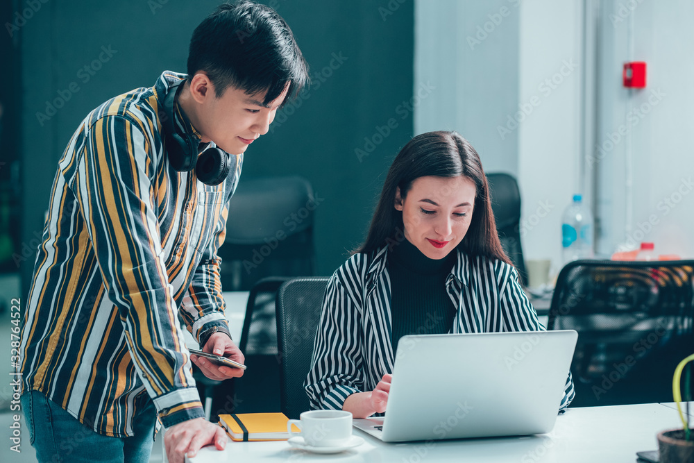 Smiling man consulting his colleague stock photo Smiling man consulting his colleague stock photo