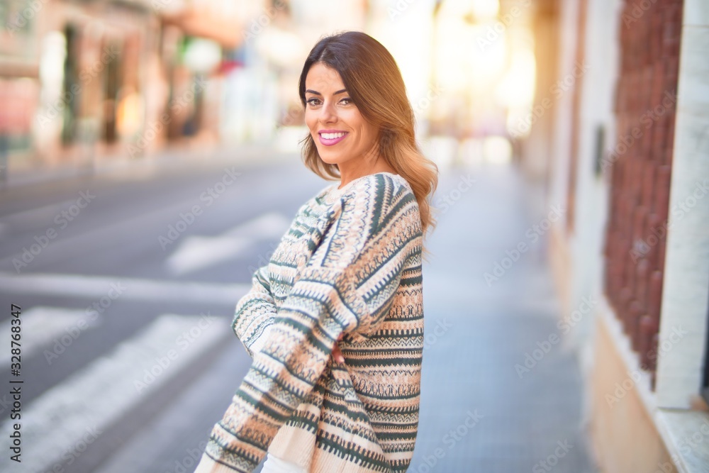 Young beautiful woman smiling happy and confident. Standing and walking at town street