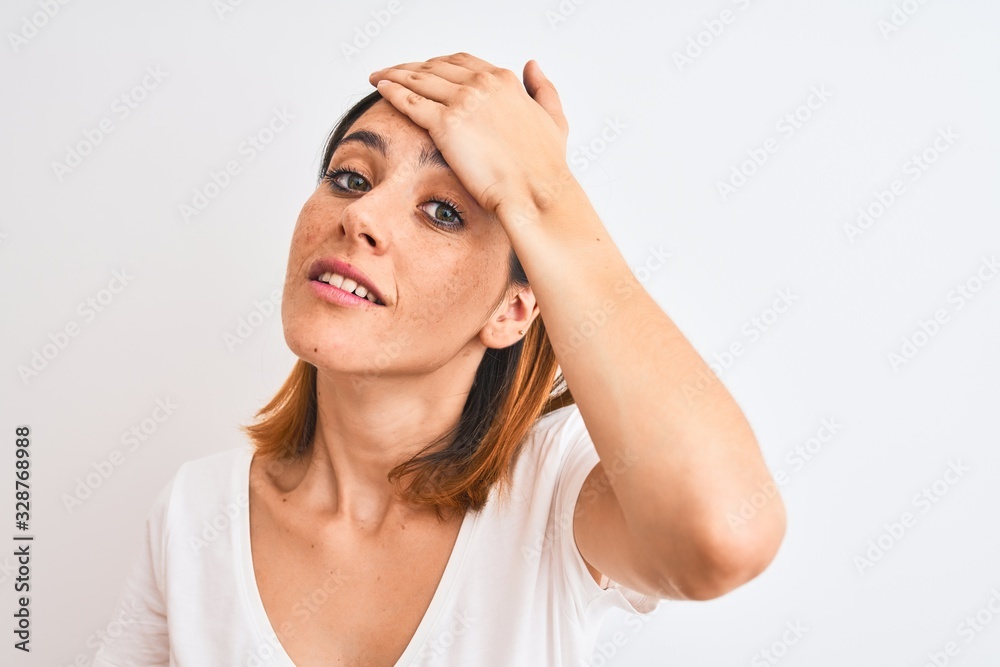 Beautiful redhead woman wearing casual white t-shirt over isolated background stressed with hand on head, shocked with shame and surprise face, angry and frustrated. Fear and upset for mistake. Beautiful redhead woman wearing casual white t-shirt over isolated background stressed with hand on head, shocked with shame and surprise face, angry and frustrated. Fear and upset for mistake.