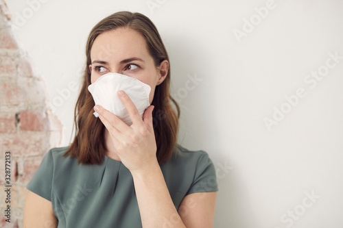 Woman wearing a mask to protect her from corona virus covid-19 with copyspace