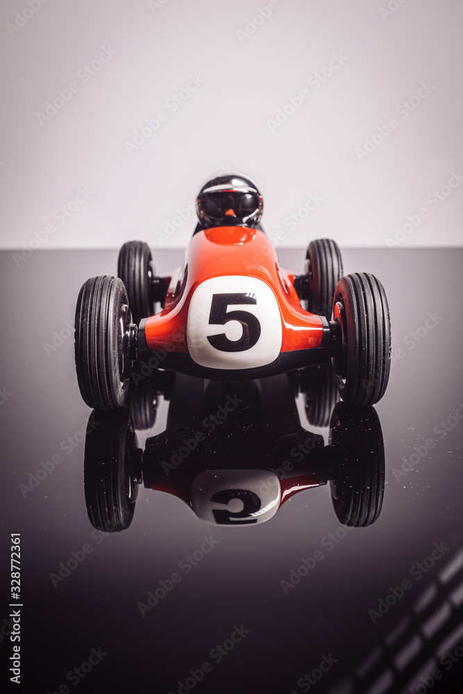 Red old racing car with number five painted on it Red old racing car with number five painted on it