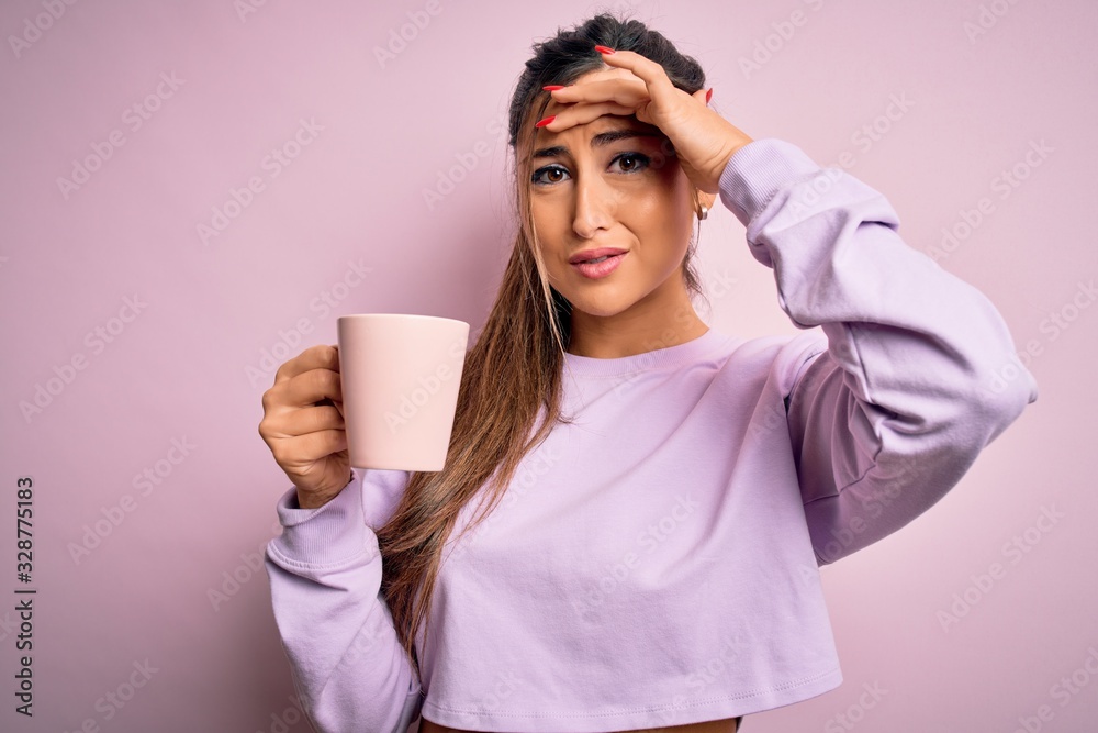 Young beautiful brunette woman drinking mug of coffee over isolated pink background stressed with hand on head, shocked with shame and surprise face, angry and frustrated. Fear and upset for mistake. Young beautiful brunette woman drinking mug of coffee over isolated pink background stressed with hand on head, shocked with shame and surprise face, angry and frustrated. Fear and upset for mistake.