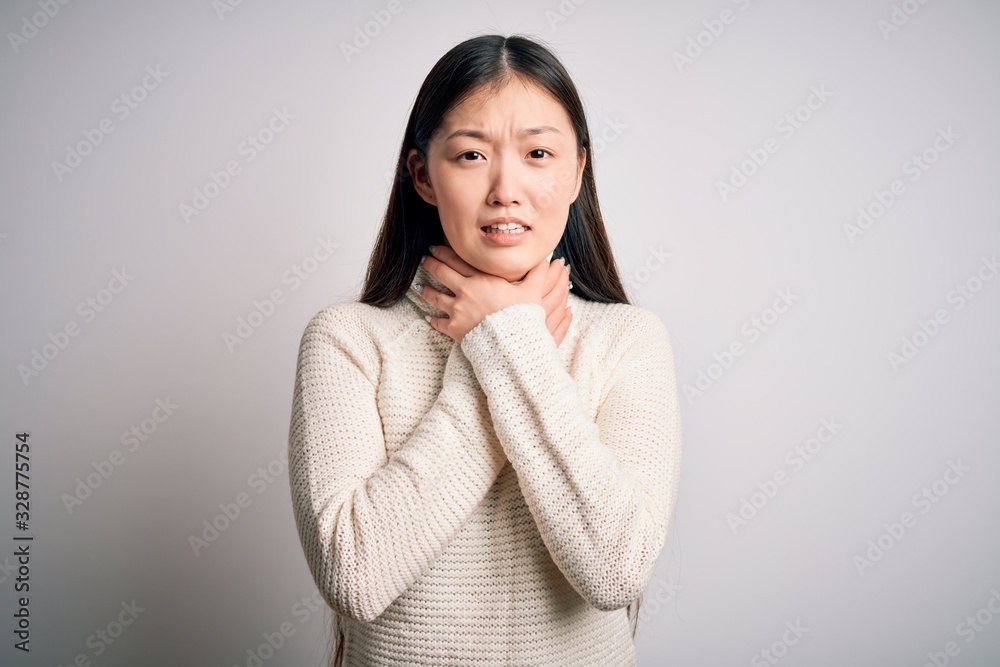 Young beautiful asian woman wearing casual sweater standing over isolated background shouting and suffocate because painful strangle. Health problem. Asphyxiate and suicide concept. Young beautiful asian woman wearing casual sweater standing over isolated background shouting and suffocate because painful strangle. Health problem. Asphyxiate and suicide concept.