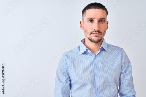 Young handsome business man standing over isolated background skeptic and nervous, frowning upset because of problem. Negative person.