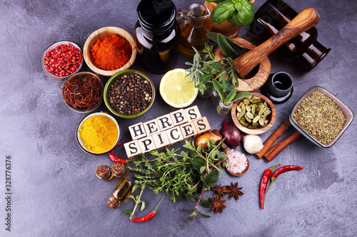 Fototapeta Naklejka Na Ścianę i Meble -  Spices and herbs on table. Food and cuisine ingredients with pepper and spices herbs sign with wooden cubes