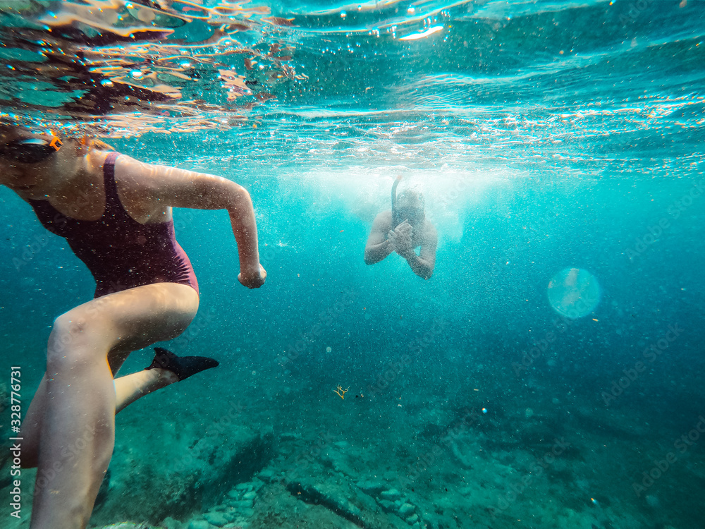 Father and daughter snorkeling in the sea