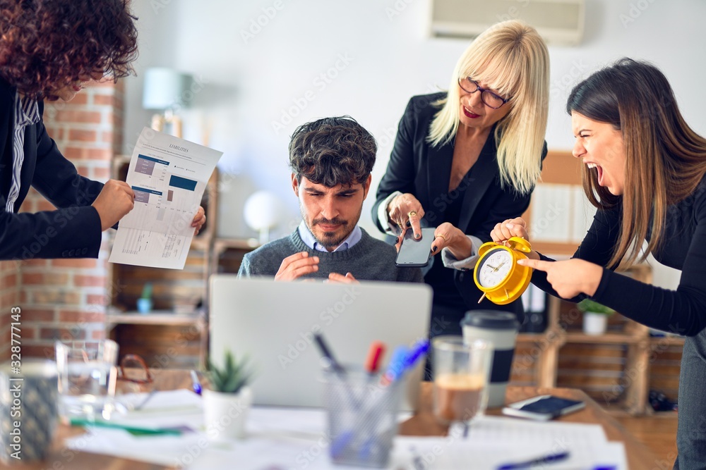 Group of business workers working together. Partners stressing one of them at the office