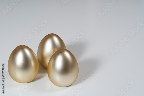 Golden easter eggs on the white table.
