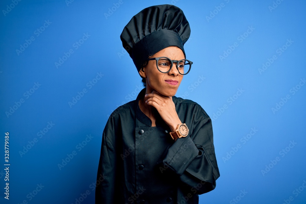 Young african american chef woman wearing cooker uniform and hat over blue background Touching painful neck, sore throat for flu, clod and infection Young african american chef woman wearing cooker uniform and hat over blue background Touching painful neck, sore throat for flu, clod and infection