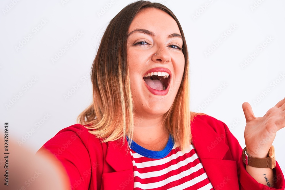 Beautiful woman wearing striped t-shirt and jacket standing over isolated white background very happy and excited, winner expression celebrating victory screaming with big smile and raised hands