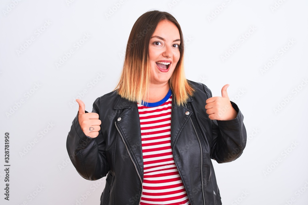 Young beautiful woman wearing striped shirt and jacket over isolated white background success sign doing positive gesture with hand, thumbs up smiling and happy. Cheerful expression Young beautiful woman wearing striped shirt and jacket over isolated white background success sign doing positive gesture with hand, thumbs up smiling and happy. Cheerful expression