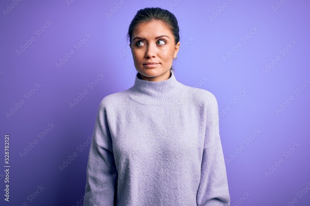 Young beautiful woman with blue eyes wearing casual turtleneck sweater over pink background smiling looking to the side and staring away thinking. Young beautiful woman with blue eyes wearing casual turtleneck sweater over pink background smiling looking to the side and staring away thinking.