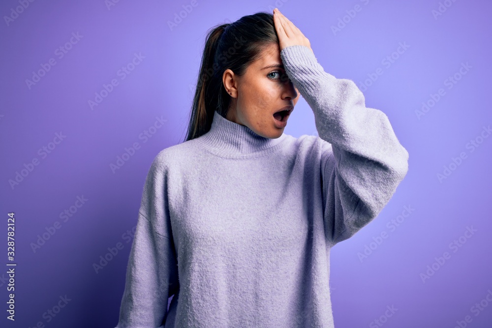 Young beautiful woman with blue eyes wearing casual turtleneck sweater over pink background surprised with hand on head for mistake, remember error. Forgot, bad memory concept. Young beautiful woman with blue eyes wearing casual turtleneck sweater over pink background surprised with hand on head for mistake, remember error. Forgot, bad memory concept.