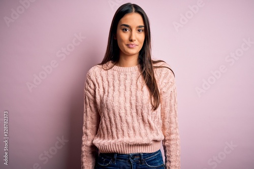 Canvas Print Young beautiful brunette woman wearing casual sweater over isolated pink background looking sleepy and tired, exhausted for fatigue and hangover, lazy eyes in the morning