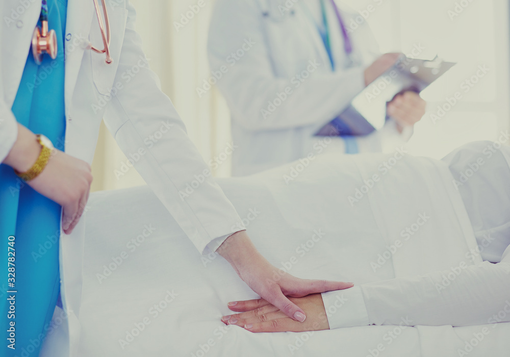 doctor or nurse talking to patient in hospital