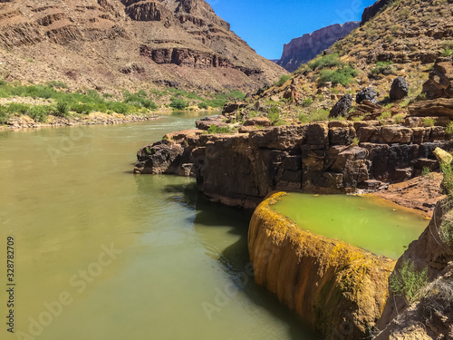 Pumpkin Spring in on the Colorado River in western Grand Canyon.  An orange  travertine bowl with arsnic-laced green waters.  Popular stop on river trips. Grand Canyon National Park, Arizona, USA photo