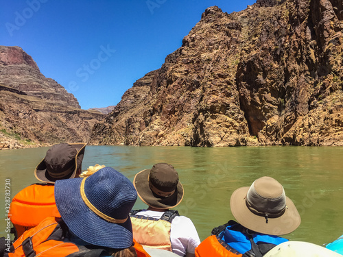 Colorado River Rafting trip with people on boat in Grand Canyon.  Inner Granite Gorge upstream from Phantom Ranch. Grand Canyon National Park, UNESCO World Heritage Site, Arizona