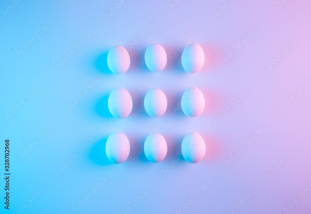 Creative simple geometrical pattern made of white chicken eggs. Creative minimal holographic Easter concept.