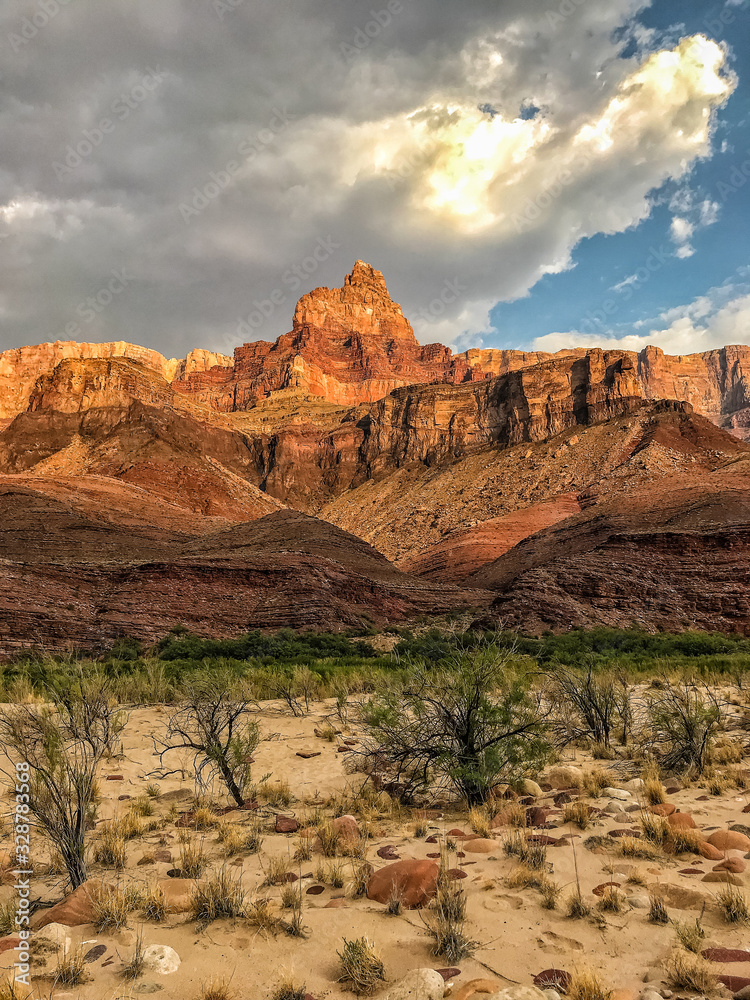 Comanche Point at Sunset.  Palisades of the Desert with clouds, rocky beach, and Colorado River.  In Furnace Flats and Grand Canyon Supergroup geology.  Grand Canyon National Park, Arizona