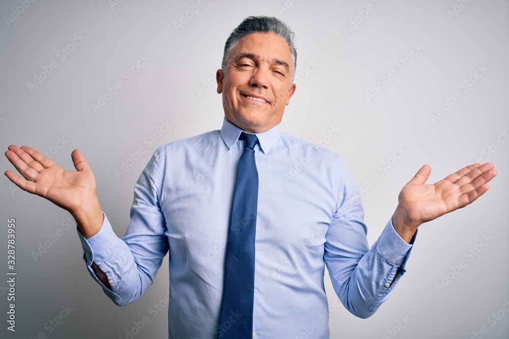 Middle age handsome grey-haired business man wearing elegant shirt and tie smiling showing both hands open palms, presenting and advertising comparison and balance