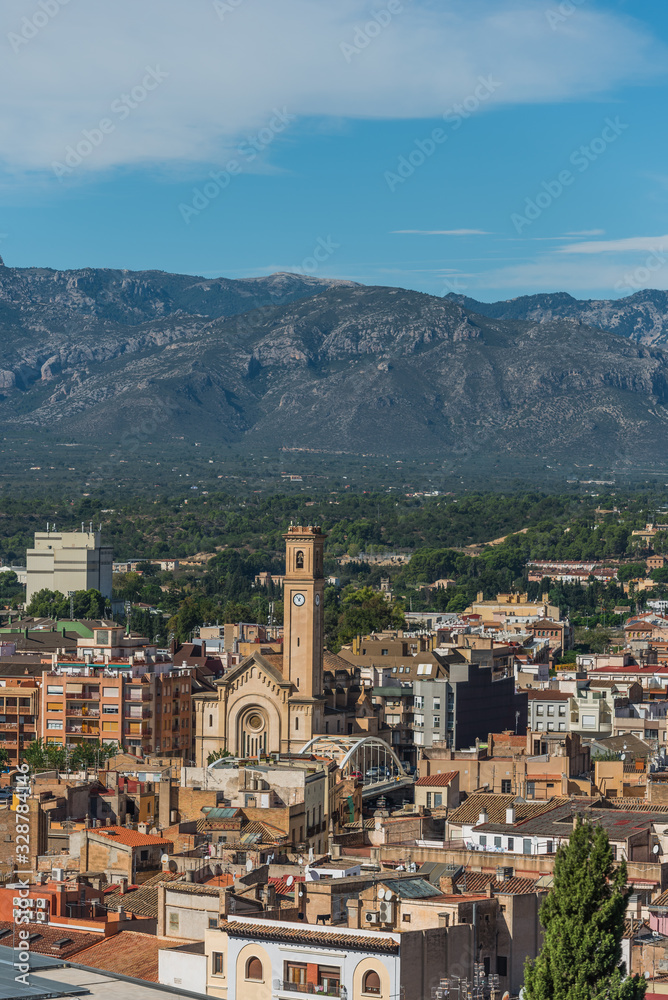 View of city buildings on a background of mountains, Tortosa, Catalonia, Tarragona, Spain. Vertical.