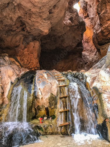 Φωτογραφία Travertine Grotto waterfalls with wood plank step and rope ladder into a cave