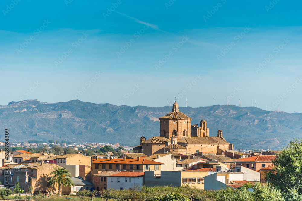 Church on a background of mountain landscape, Ginestar, province Tarragona, Catalonia, Spain. Copy space for text.