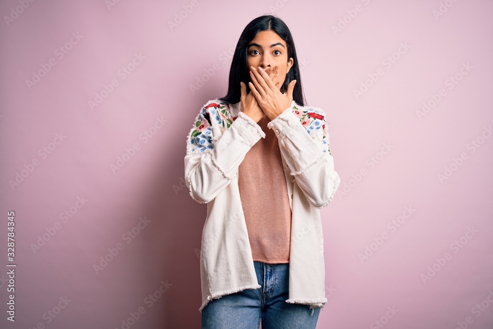 Young beautiful hispanic fashion woman wearing casual sweater over pink background shocked covering mouth with hands for mistake. Secret concept. Young beautiful hispanic fashion woman wearing casual sweater over pink background shocked covering mouth with hands for mistake. Secret concept.