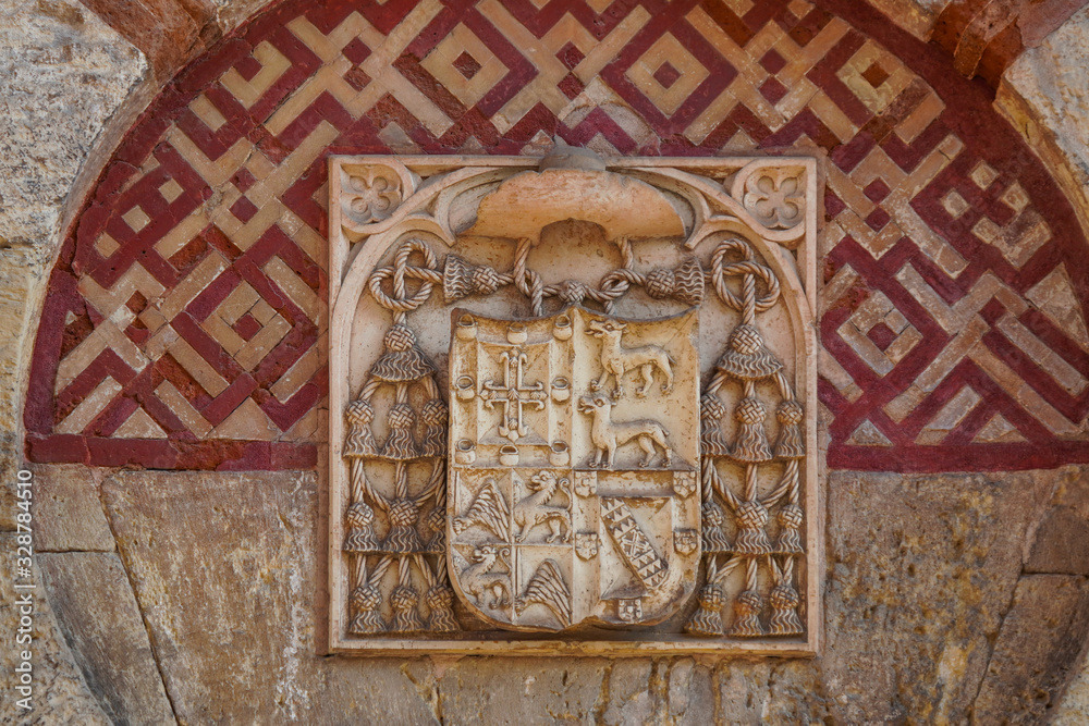 Coat of arms on the facade of the building Mosque Cathedral of Cordoba, Andalusia, Spain.