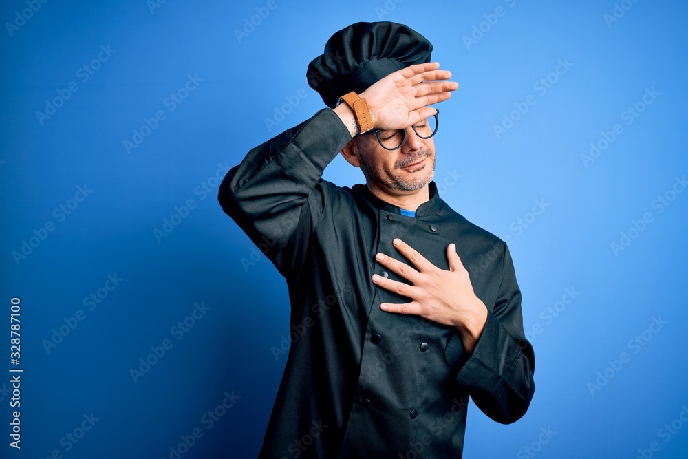 Young handsome chef man wearing cooker uniform and hat over isolated blue background Touching forehead for illness and fever, flu and cold, virus sick Young handsome chef man wearing cooker uniform and hat over isolated blue background Touching forehead for illness and fever, flu and cold, virus sick