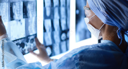 Two female women medical doctors looking at x-rays in a hospital photo