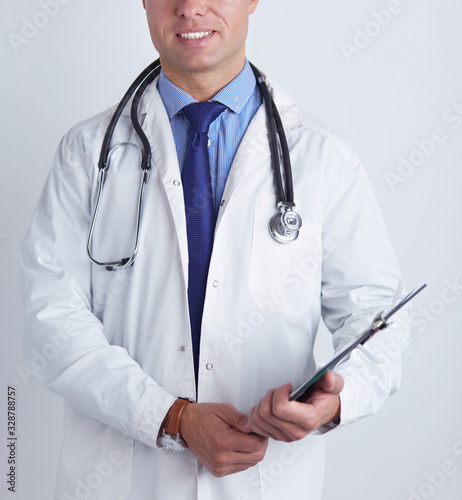 Male doctor standing with folder, isolated on white background