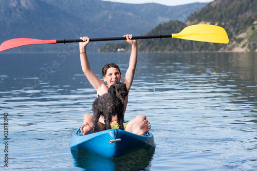 Happy young woman enjoying summer with her dog.