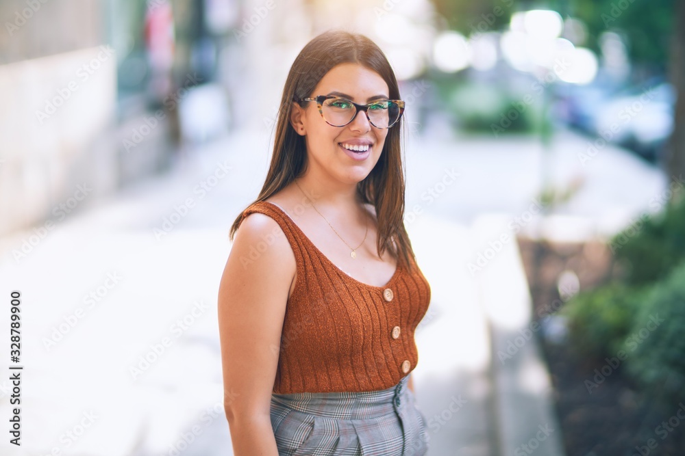 Young beautiful woman smiling happy and confident. Standing with smile on face at the town street Young beautiful woman smiling happy and confident. Standing with smile on face at the town street